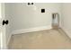 A close up shot of a laundry room with light gray walls, white trim, and electrical and dryer hookups at 5377 River Buck Rd, Spring Hope, NC 27882