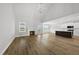 Open-concept living room with hardwood floors, a fireplace, and a kitchen island at 5377 River Buck Rd, Spring Hope, NC 27882