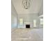 Bright living room featuring neutral walls, a white fireplace, and large windows that let in plenty of natural light at 5377 River Buck Rd, Spring Hope, NC 27882