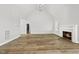 Spacious living room with hardwood floors and a fireplace, showcasing modern design at 5377 River Buck Rd, Spring Hope, NC 27882