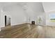 Spacious living room featuring hardwood floors, a fireplace, and a modern chandelier at 5377 River Buck Rd, Spring Hope, NC 27882