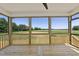 This screened porch features wood flooring, a ceiling fan, and a view of the property at 5377 River Buck Rd, Spring Hope, NC 27882