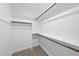 This walk-in closet features shelves, wood rods, and neutral carpeting at 5377 River Buck Rd, Spring Hope, NC 27882