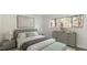 Spacious bedroom with light walls, gray dresser, and green bedding at 550 Pine Ridge Pl, Raleigh, NC 27609