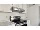 Stainless steel range and overhead vent hood in bright kitchen at 550 Pine Ridge Pl, Raleigh, NC 27609