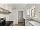 White kitchen with stainless steel appliances and marble countertops at 550 Pine Ridge Pl, Raleigh, NC 27609