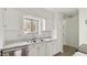 Bright kitchen features white cabinets, stainless steel appliances, and marble countertops at 550 Pine Ridge Pl, Raleigh, NC 27609
