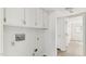 Laundry closet with upper cabinets and hookups for washer and dryer at 550 Pine Ridge Pl, Raleigh, NC 27609