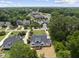 An aerial view shows this modern home surrounded by mature trees in a well-developed neighborhood at 5820 Shawood Dr, Raleigh, NC 27609