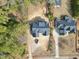 Aerial view of a new home with a dark roof, neighboring houses, and a spacious backyard at 5820 Shawood Dr, Raleigh, NC 27609