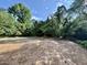 Cleared backyard with mature trees, perfect for building a new home or outdoor activities at 5820 Shawood Dr, Raleigh, NC 27609