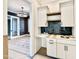 Stylish bar area boasts custom cabinetry and a unique tiled backsplash at 5820 Shawood Dr, Raleigh, NC 27609