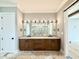 Bright bathroom features double vanity with marble countertops and large mirrors with modern lighting at 5820 Shawood Dr, Raleigh, NC 27609