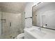 Modern bathroom features a glass-enclosed shower with a built-in bench and sleek vanity at 5820 Shawood Dr, Raleigh, NC 27609