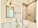 Bathroom featuring a shower over tub, neutral tile and a vanity with a square mirror at 5820 Shawood Dr, Raleigh, NC 27609
