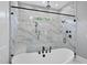 Bright bathroom with white marble, freestanding tub, walk-in shower with overhead fixture at 5820 Shawood Dr, Raleigh, NC 27609