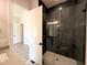 This bathroom features a glass shower, black hardware, and neutral paint colors at 5820 Shawood Dr, Raleigh, NC 27609