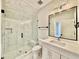 Modern bathroom features a glass shower, toilet, vanity, and a large rectangular mirror at 5820 Shawood Dr, Raleigh, NC 27609