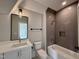 Modern bathroom features a shower, tub, and vanity with a dark tiled backsplash at 5820 Shawood Dr, Raleigh, NC 27609