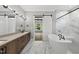 Elegant bathroom with dual sinks, marble flooring, soaking tub, glass shower, and barn door at 5820 Shawood Dr, Raleigh, NC 27609