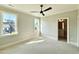 Bedroom with neutral carpet, ceiling fan, and attached bathroom with a modern design at 5820 Shawood Dr, Raleigh, NC 27609