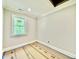 Bright bedroom features a large window, neutral walls, and white trim at 5820 Shawood Dr, Raleigh, NC 27609