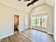 Bright bedroom with vaulted ceiling, wood flooring, and a large window offering backyard views at 5820 Shawood Dr, Raleigh, NC 27609