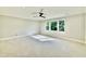 Bright bedroom with a ceiling fan, neutral carpet, white trim, and large windows at 5820 Shawood Dr, Raleigh, NC 27609