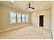 Bedroom with ceiling fan, neutral walls, white trim, and plenty of natural light, plus a bathroom at 5820 Shawood Dr, Raleigh, NC 27609