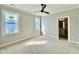 Bedroom with ceiling fan, neutral walls, white trim, and plenty of natural light, plus a bathroom at 5820 Shawood Dr, Raleigh, NC 27609