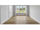 Bright bedroom with large window and light hardwood floors at 5820 Shawood Dr, Raleigh, NC 27609