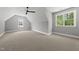 Large bedroom features neutral carpet and windows offering natural light from unique angles at 5820 Shawood Dr, Raleigh, NC 27609
