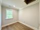 Bright bedroom with hardwood floors, neutral paint, and a window providing natural light at 5820 Shawood Dr, Raleigh, NC 27609