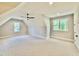 Spacious bedroom with carpeting, ceiling fan, neutral paint and lots of natural light from two windows at 5820 Shawood Dr, Raleigh, NC 27609
