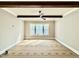 Bonus room featuring wood beam accents, ceiling fan, and a bright window at 5820 Shawood Dr, Raleigh, NC 27609
