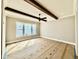 Bonus room with wood beam accents, ceiling fan, and ample natural light at 5820 Shawood Dr, Raleigh, NC 27609