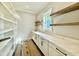 Butler's pantry featuring a marble countertop, shaker cabinets, and open wood shelving at 5820 Shawood Dr, Raleigh, NC 27609