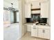 Butler's pantry area with granite countertop and tiled backsplash at 5820 Shawood Dr, Raleigh, NC 27609