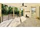 Covered back patio with a stone floor and ceiling fan with a fireplace at 5820 Shawood Dr, Raleigh, NC 27609