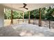 Covered patio complete with stone flooring, ceiling fan and natural views at 5820 Shawood Dr, Raleigh, NC 27609
