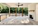Covered patio complete with stone flooring, ceiling fan, brick fireplace and natural views at 5820 Shawood Dr, Raleigh, NC 27609