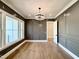 Dining room showcases wainscotting detail, modern lighting and hardwood flooring at 5820 Shawood Dr, Raleigh, NC 27609