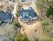 An aerial view shows a new home featuring a striking roof design situated on a spacious lot at 5820 Shawood Dr, Raleigh, NC 27609