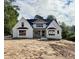 Stunning new construction, white brick home featuring black trim and dark roof at 5820 Shawood Dr, Raleigh, NC 27609