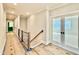Bright hallway features a wooden staircase, white walls, and a doorway leading to another room at 5820 Shawood Dr, Raleigh, NC 27609