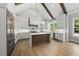 Open kitchen with a center island, stainless steel appliances, wood accents, and vaulted ceilings at 5820 Shawood Dr, Raleigh, NC 27609