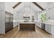 Bright kitchen with stainless steel appliances, a center island, hardwood floors, and a vaulted ceiling at 5820 Shawood Dr, Raleigh, NC 27609
