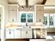 Bright, modern kitchen sink area with white cabinets and stainless dishwasher at 5820 Shawood Dr, Raleigh, NC 27609
