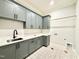 Laundry room with lots of cabinetry, counter space, sink, and nice floors at 5820 Shawood Dr, Raleigh, NC 27609