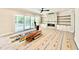 Spacious living room with fireplace, sliding glass doors, and ceiling fan at 5820 Shawood Dr, Raleigh, NC 27609